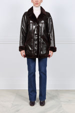 The Vermilion Patent Shearling Coat