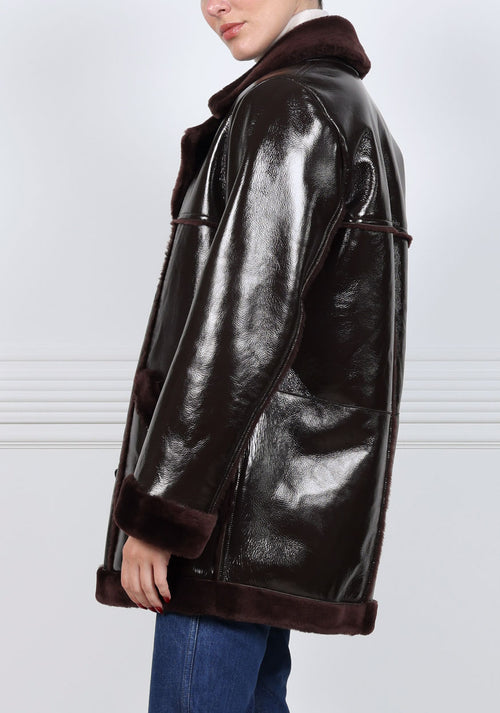 The Vermilion Patent Shearling Coat