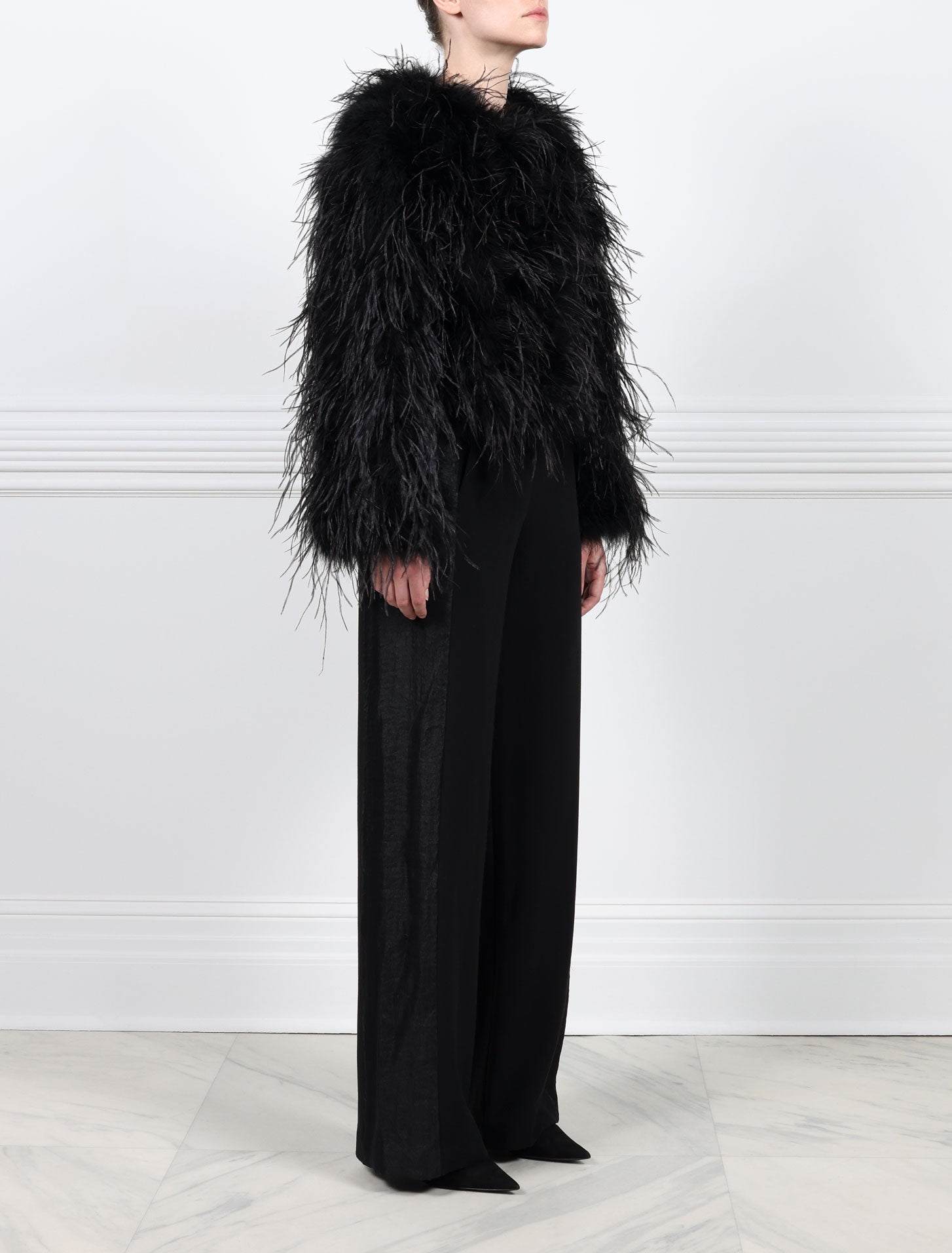 SIDE VIEW-BLACK OSTRICH FEATHER JACKET-CREW NECK-FULL LENGTH STRAIGHT SLEEVES-SLIT POCKETS-HOOK AND EYE CLOSURES-20 INCH CENTER BACK LENGTH-BY POLOGEORGIS