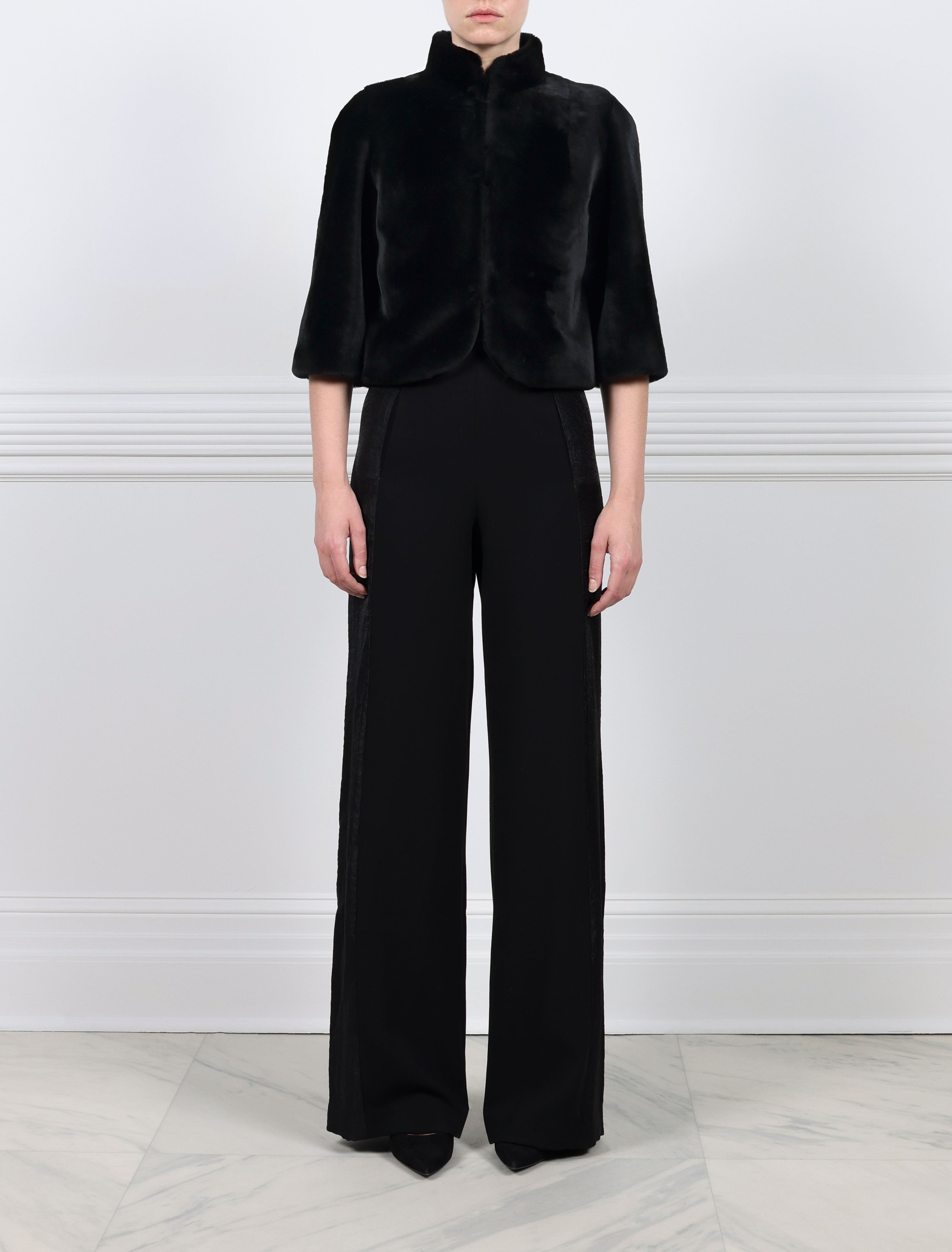 FRONT VIEW-BLACK SHEARLING JACKET-ROUNDED STAND COLLAR-THREE QUARTER LENGTH SLEEVES-HOOK AND EYE CLOSURES-19 INCH CENTER BACK LENGTH-BY POLOGEORGIS