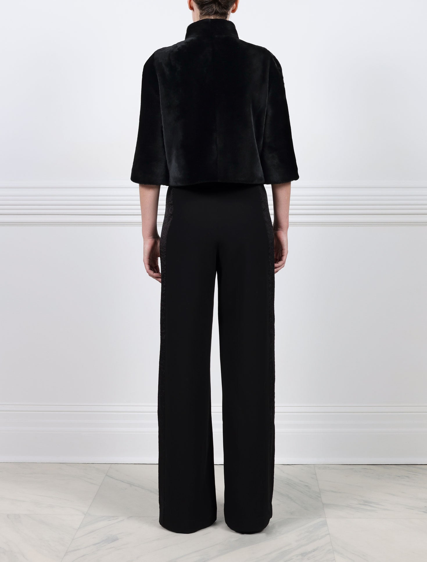 BACK VIEW-BLACK SHEARLING JACKET-ROUNDED STAND COLLAR-THREE QUARTER LENGTH SLEEVES-HOOK AND EYE CLOSURES-19 INCH CENTER BACK LENGTH-BY POLOGEORGIS