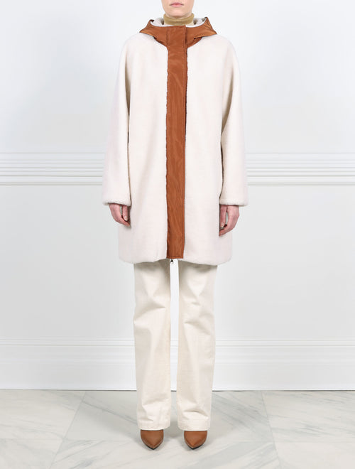 FRONT VIEW SHEARLING SIDE-IVORY SHEARLING ANORAK REVERSIBLE TO CONTRASTING COCO TECHNO FABRIC-HOODED-FULL LENGTH SLEEVES-FLAP POCKETS-HIDDEN FRONT SNAPS OVER ZIPPER CLOSURE-31 INCH CENTER BACK LENGTH-BY POLOGEORGIS