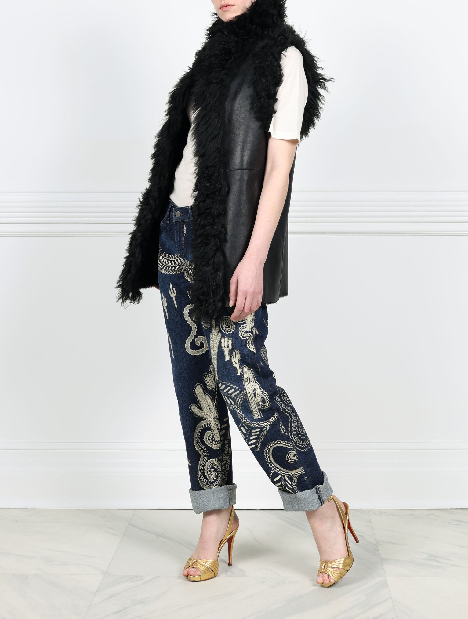 KNITTED FLOWER PRINTED ON BLACK REVERSIBLE SHEARLING VEST DESIGNED BY ZANDRA RHODES FOR POLOGEORGIS-STAND COLLAR-SLIT POCKETS-SNAP CLOSURES-CURLY SHEARLING TRIM AT ARMHOLES AND TUXEDO-30 INCH CENTER BACK LENGTH