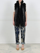 FRONT VIEW-KNITTED FLOWER PRINTED ON BLACK REVERSIBLE SHEARLING VEST DESIGNED BY ZANDRA RHODES FOR POLOGEORGIS-STAND COLLAR-SLIT POCKETS-SNAP CLOSURES-CURLY SHEARLING TRIM AT ARMHOLES AND TUXEDO-30 INCH CENTER BACK LENGTH