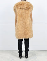 TAN OVERSIZED HOODED SHEARLING VEST DESIGNED BY MICHAEL KORS FOR POLOGEORGIS-DOUBLE FUR HOOD-HOOK AND EYE CLOSURES-31 INCH CENTER BACK LENGTH