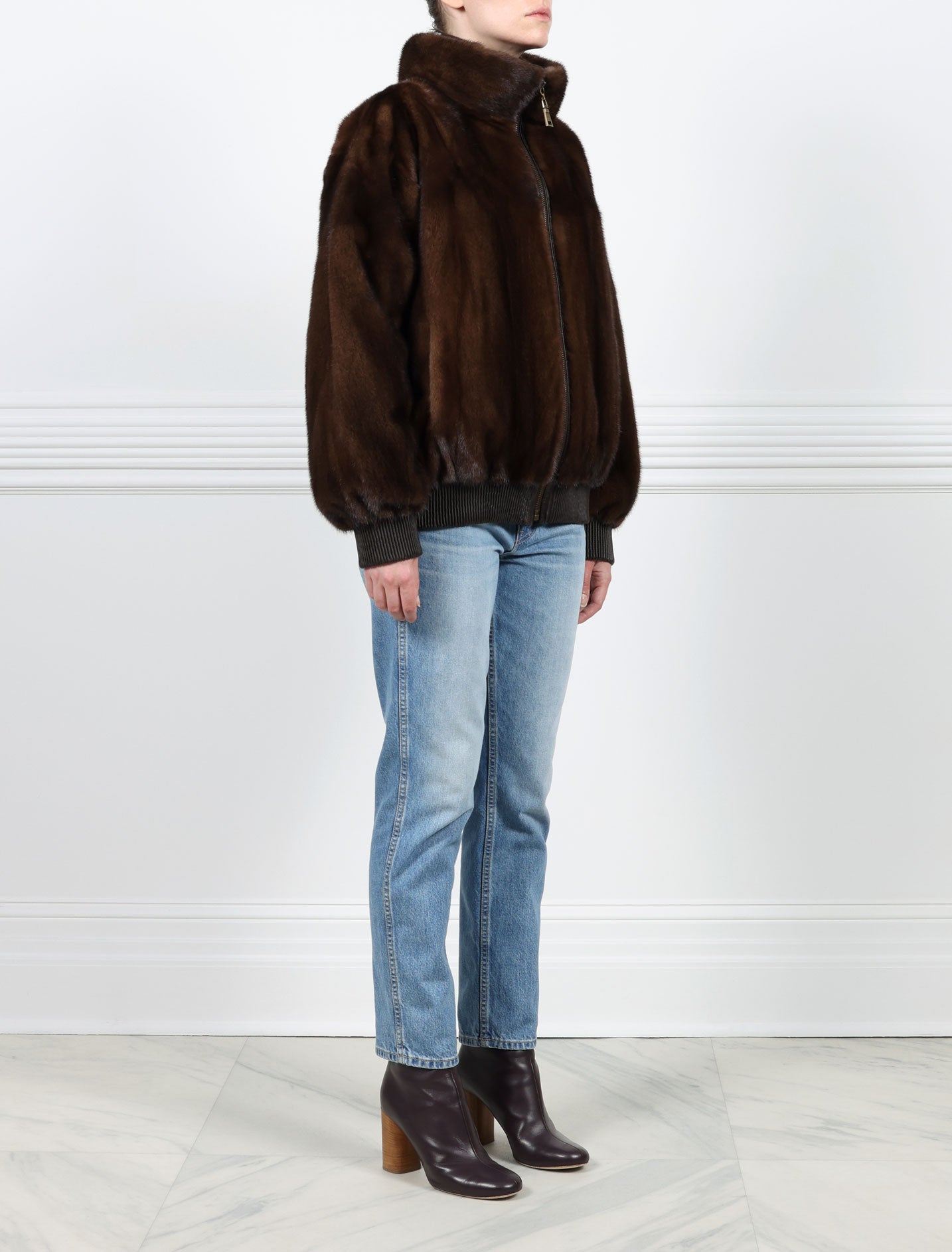 SIDE VIEW-MAHOGANY MINK BOMBER JACKET-STAND COLLAR-FULL LENGTH SLEEVES-SLIT POCKETS-FRONT ZIP CLOSURE-GATHERED LEATHER TRIM AT WRISTS AND WAIST -25 INCH CENTER BACK LENGTH-BY POLOGEORGIS