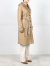 SIDE VIEW-TAN SHEARLING TRENCH COAT-NOTCH COLLAR-FULL LENGTH SLEEVES WITH BUTTON TABS-SLIT POCKETS-LEATHER BELT-42 INCH CENTER BACK LENGTH- BY POLOGEORGIS