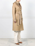 SIDE VIEW-TAN SHEARLING TRENCH COAT-NOTCH COLLAR-FULL LENGTH SLEEVES WITH BUTTON TABS-SLIT POCKETS-LEATHER BELT-42 INCH CENTER BACK LENGTH- BY POLOGEORGIS