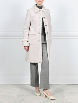 ACTION VIEW-WHITE SHEARLING BALMACAAN COAT-FUR SHIRT COLLAR-STRAIGHT FULL LENGTH SLEEVES WITH BUTTON TABS-FUR TRIMMED PATCH POCKETS, TUXEDO AND SLEEVE ENDS-BUTTON CLOSURES-38 INCH CENTER BACK LENGTH-BY POLOGEORGIS