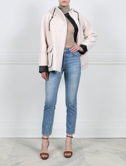 ACTION VIEW-IVORY HOODED BOMBER JACKET WITH BLACK LEATHER TRIM-DRAWSTRING HOOD  WITH METAL STOPPERS-FULL LENGTH SLEEVES WITH BLACK LEATHER CUFFS-BLACK LEATHER TRIMMED FLAP POCKETS-HIDDEN ZIP CLOSURE-28 INCH CENTER BACK LENGTH-BY POLOGEORGIS